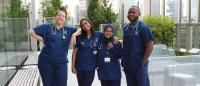 Group of four nursing students standing outside on a deck